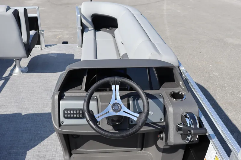Slide: The Image of 2026 Sun Tracker SportFish 20 DLX boat interior with steering wheel and seating. - 10