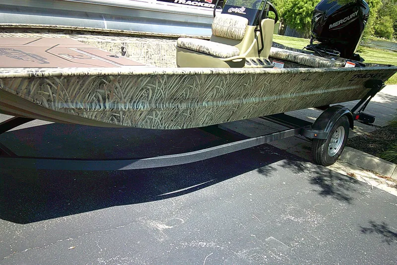 The Image of 2026 Tracker Grizzly 1860 CC boat with camouflage design on a trailer. - 0