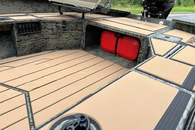 Slide: The Image of 2026 Tracker Grizzly 1756 T Marsh boat interior with camouflage design and red fuel tank. - 13