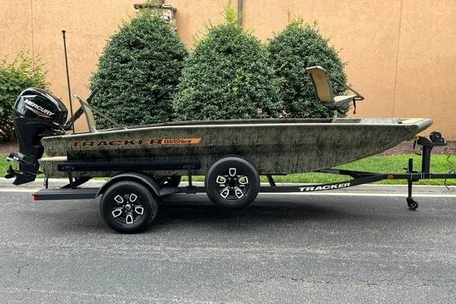 The Image of 2026 Tracker Grizzly 1756 T Marsh boat on trailer, parked outdoors. - 0