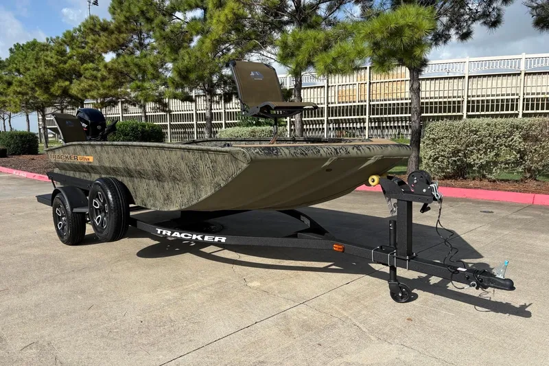 Slide: The Image of 2026 Tracker Grizzly 1756 T Marsh boat on trailer, parked outdoors. - 2