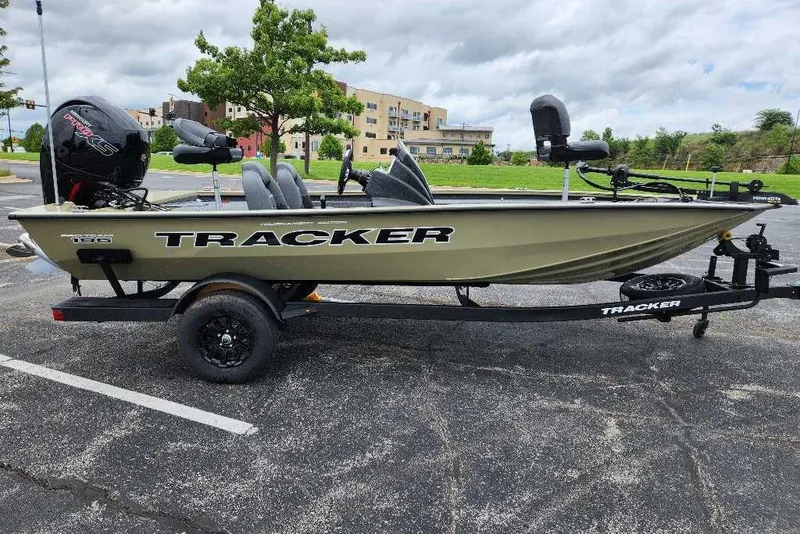 Slide: The Image of 2026 Tracker Pro Team 195 boat on trailer in parking lot. - 2