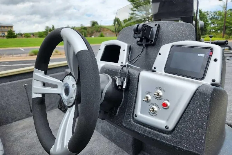 Slide: The Image of Steering console of 2026 Tracker Pro Team 195 boat with modern controls and display. - 7