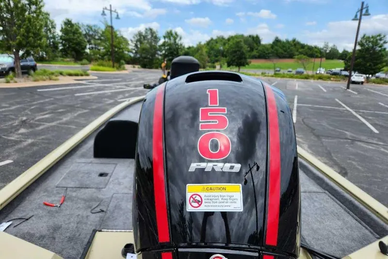 Slide: The Image of 2026 Tracker Pro Team 195 boat engine with "150 Pro" label in parking lot. - 9
