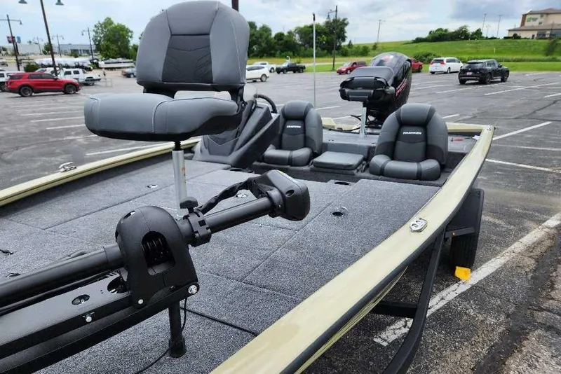Slide: The Image of 2026 Tracker Pro Team 195 boat in parking lot, featuring seating and motor. - 8