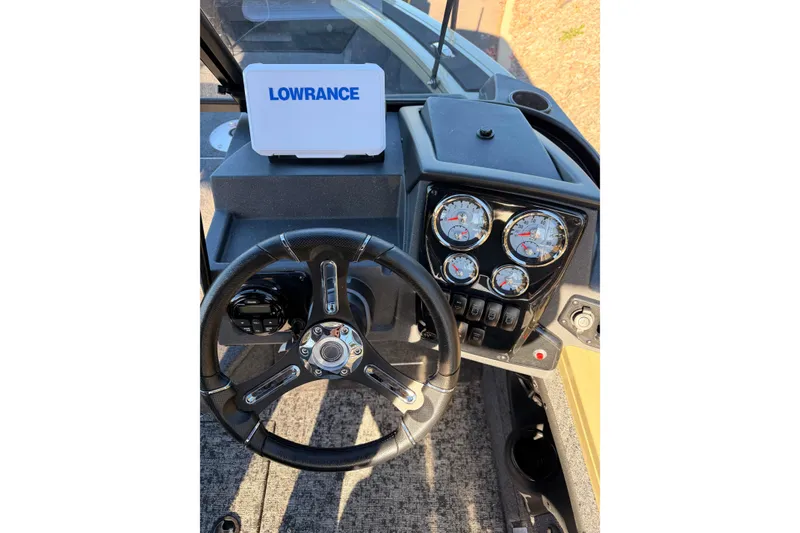 Slide: The Image of 2026 Tracker Targa V-19 Combo dashboard with Lowrance device and steering wheel. - 4
