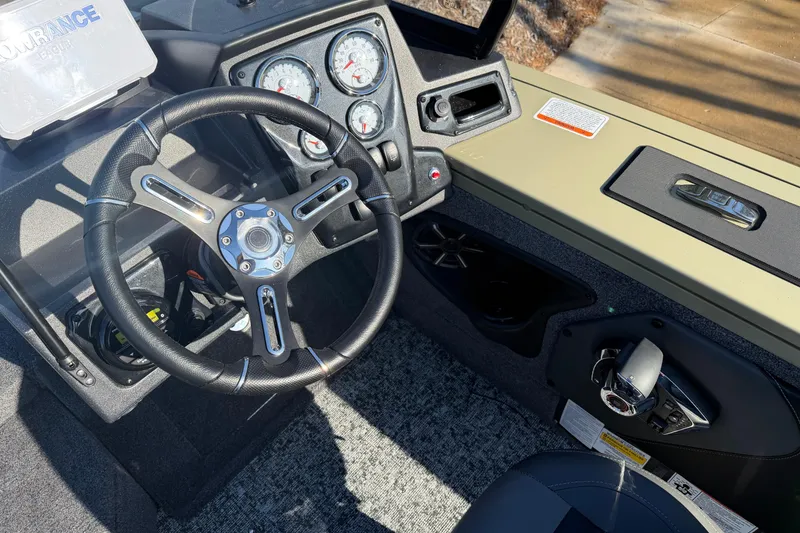 The Image of 2026 Tracker Targa V-19 Combo boat dashboard with steering wheel and control panel. - 0