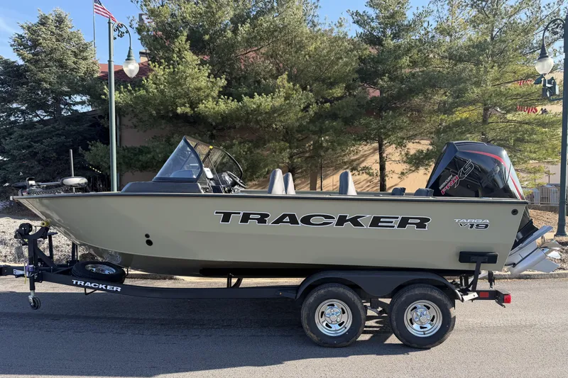 Slide: The Image of 2026 Tracker Targa V-19 Combo boat on trailer, parked outdoors. - 2