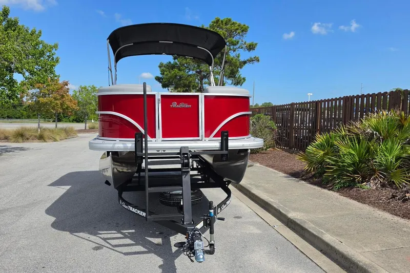 Slide: The Image of 2026 Sun Tracker Party Barge 20 DLX pontoon boat on trailer, parked outdoors. - 6