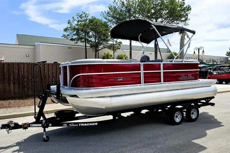 Slide: The Image of 2026 Sun Tracker Party Barge 20 DLX pontoon boat on trailer, parked outdoors. - 8
