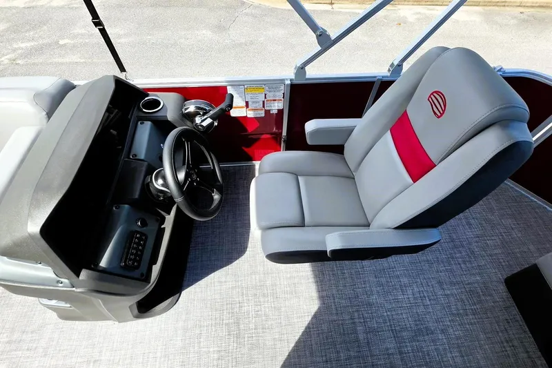 Slide: The Image of 2026 Sun Tracker Party Barge 20 DLX helm with modern steering and comfortable seating. - 11