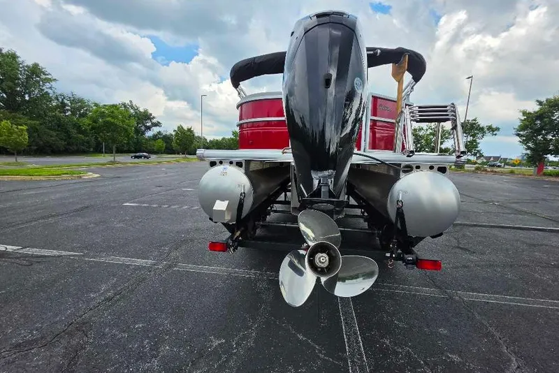 Slide: The Image of 2026 Sun Tracker Party Barge 20 DLX pontoon boat in parking lot, rear view. - 83