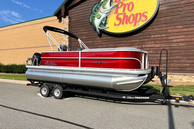 Slide: The Image of 2026 Sun Tracker Party Barge 20 DLX pontoon boat on trailer outside Pro Shops. - 3