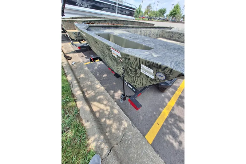 Slide: The Image of 2026 Tracker Grizzly 1860 Utility boat on trailer in parking lot. - 19