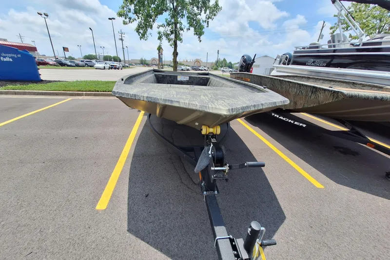 Slide: The Image of 2026 Tracker Grizzly 1860 Utility boat on trailer in parking lot. - 16