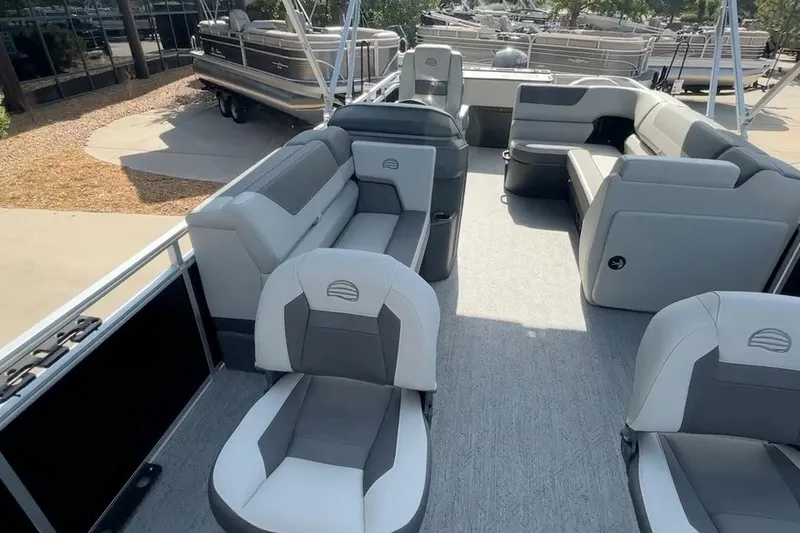 Slide: The Image of 2026 Sun Tracker Fishin' Barge 22 DLX pontoon boat with spacious seating and modern design. - 8
