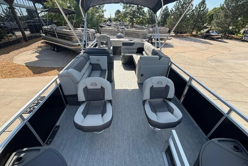 Slide: The Image of 2026 Sun Tracker Fishin' Barge 22 DLX pontoon boat with spacious seating and canopy. - 3