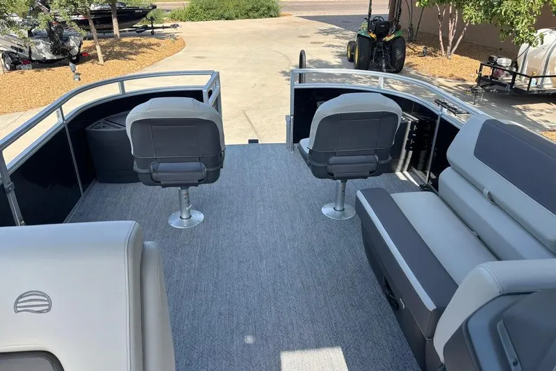 Slide: The Image of 2026 Sun Tracker Fishin' Barge 22 DLX interior with seating and fishing chairs. - 10