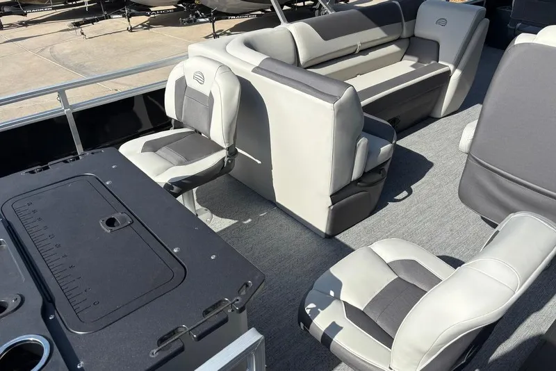 Slide: The Image of 2026 Sun Tracker Fishin' Barge 22 DLX interior with comfortable seating and fishing station. - 9