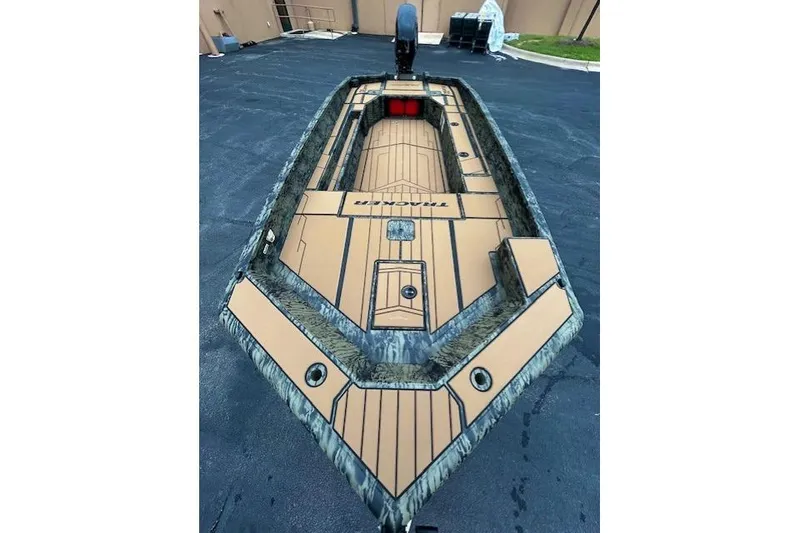 Slide: The Image of 2026 Tracker Grizzly 1756 T Marsh boat with camouflage design on a paved surface. - 4