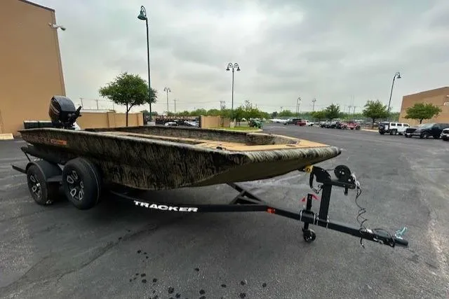 Slide: The Image of 2026 Tracker Grizzly 1756 T Marsh boat on trailer in parking lot. - 2