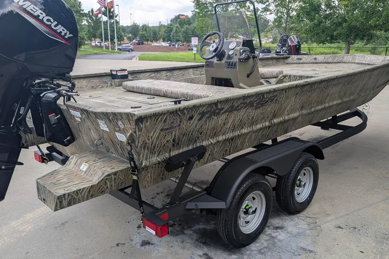 Slide: The Image of 2026 Tracker Grizzly 2072 CC boat with camouflage design on a trailer. - 2