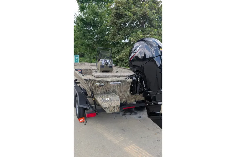 Slide: The Image of 2026 Tracker Grizzly 2072 CC boat with camouflage design and Mercury outboard motor. - 9