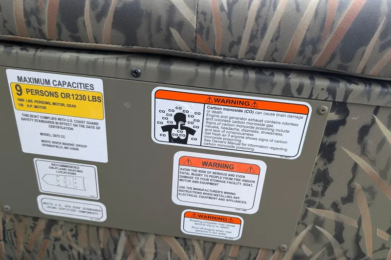 Slide: The Image of Warning labels on 2026 Tracker Grizzly 2072 CC boat, detailing capacity and safety information. - 3