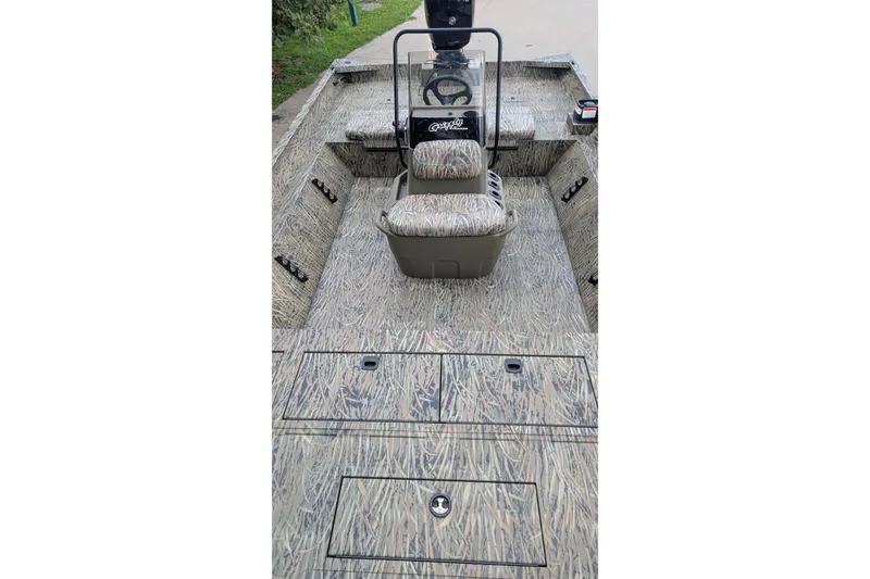 Slide: The Image of 2026 Tracker Grizzly 2072 CC boat interior with camouflage design and central console. - 5