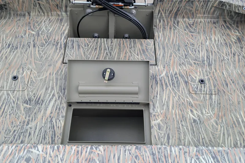 Slide: The Image of 2026 Tracker Grizzly 2072 CC boat interior with camo pattern and storage compartment. - 6