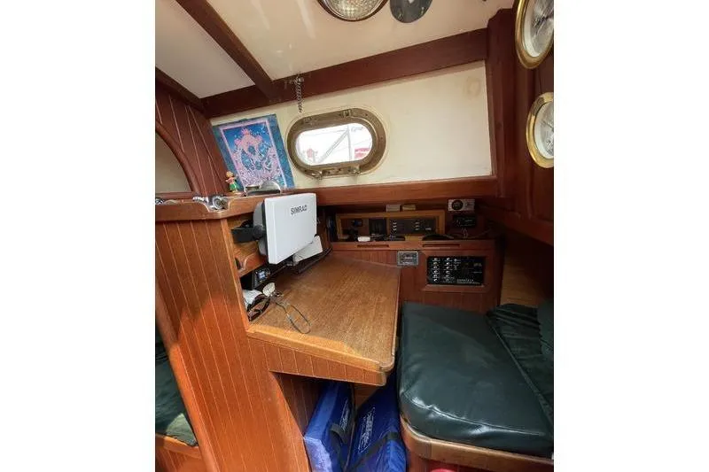 Slide: The Image of 1980 Ta Shing Baba 30 sailboat interior with navigation station and wooden finish. - 10