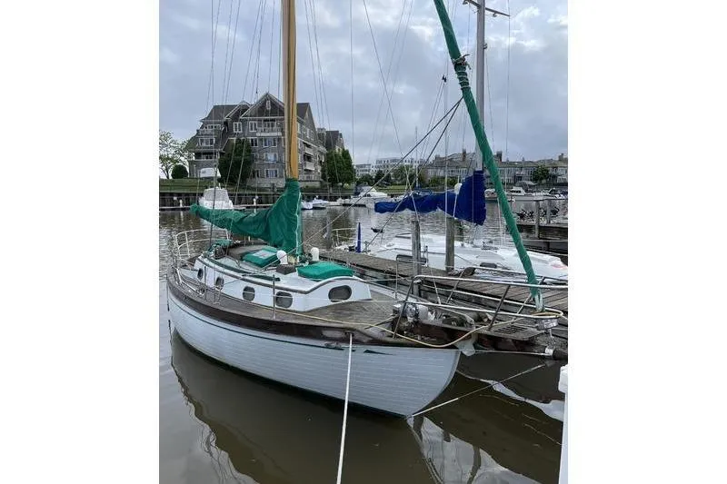 Slide: The Image of 1980 Ta Shing Baba 30 sailboat docked in a marina with overcast skies. - 5