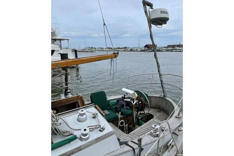 Slide: The Image of 1980 Ta Shing Baba 30 sailboat cockpit with marina view, featuring navigation equipment. - 3