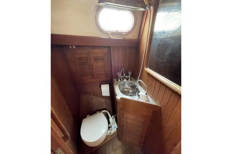 Slide: The Image of Compact bathroom in 1980 Ta Shing Baba 30 sailboat with wooden interior and porthole window. - 13