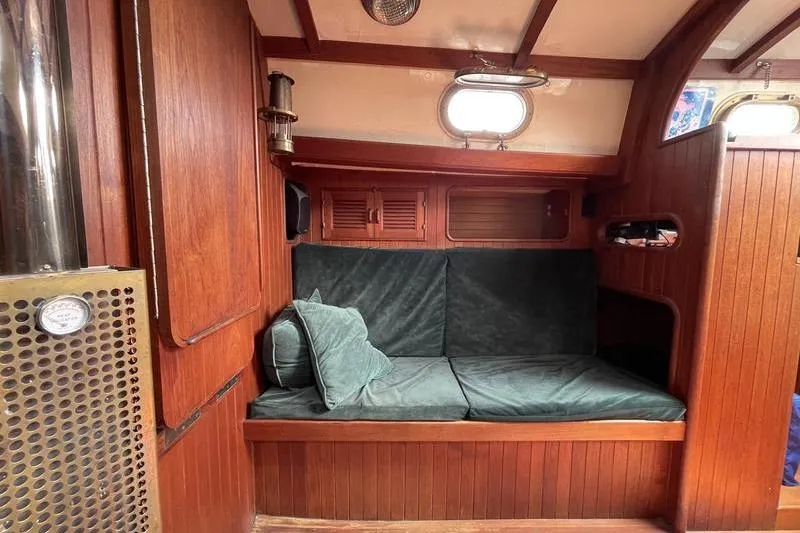 Slide: The Image of Interior of 1980 Ta Shing Baba 30 sailboat with wooden paneling and green cushions. - 7