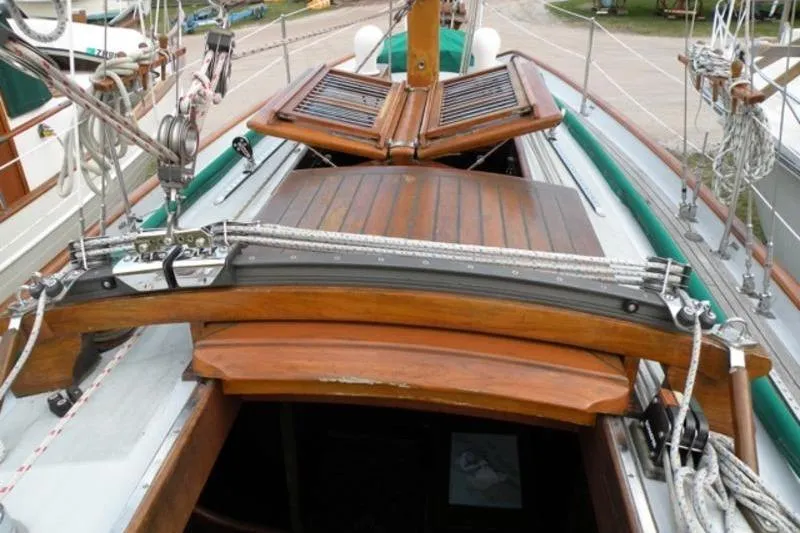 Slide: The Image of 1980 Ta Shing Baba 30 sailboat deck with wooden hatch and rigging details. - 2