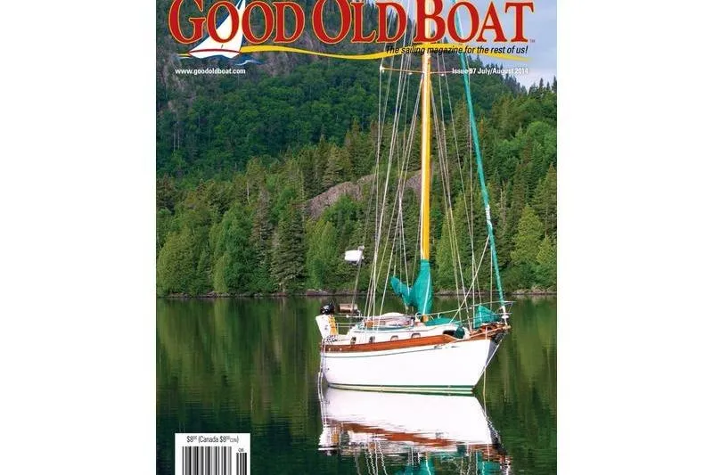 Slide: The Image of Sailboat on calm lake, surrounded by lush forest, featured on "Good Old Boat" magazine cover. - 14