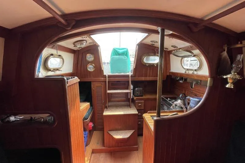 Slide: The Image of Interior of 1980 Ta Shing Baba 30 sailboat with wooden finishes and nautical decor. - 12