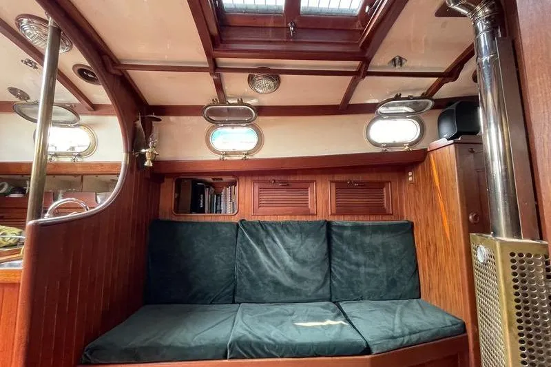 Slide: The Image of Interior of 1980 Ta Shing Baba 30 sailboat with wooden paneling and cushioned seating. - 8