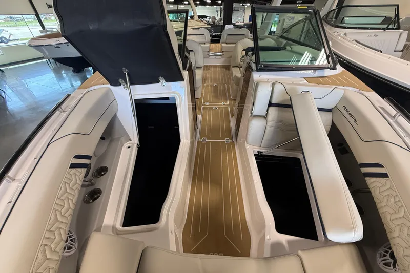 Slide: The Image of 2027 Regal LS9 boat interior with luxurious seating and sleek design. - 19