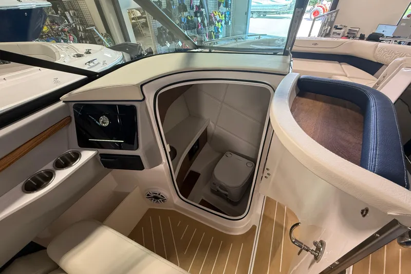 Slide: The Image of Interior of 2027 Regal LS9 boat featuring a compact bathroom with modern amenities. - 13