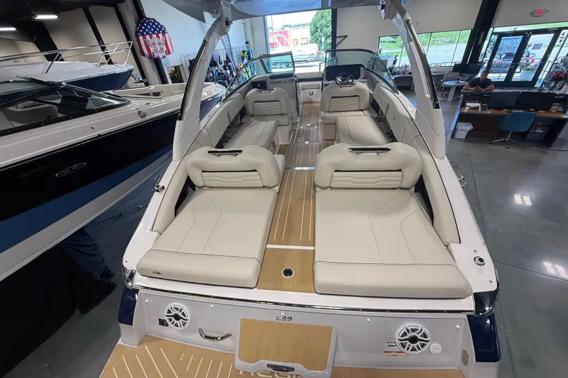 Slide: The Image of 2027 Regal LS9 boat interior with beige seating and modern design in showroom. - 5