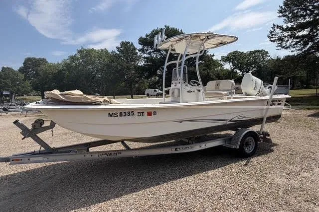 The Image of 2017 Carolina Skiff 21 DLX boat on trailer, parked outdoors. - 0