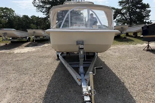 Slide: The Image of 2017 Carolina Skiff 21 DLX boat on trailer, parked outdoors. - 2