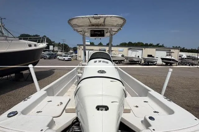 Slide: The Image of 2017 Carolina Skiff 21 DLX boat with T-top in a marina setting. - 9