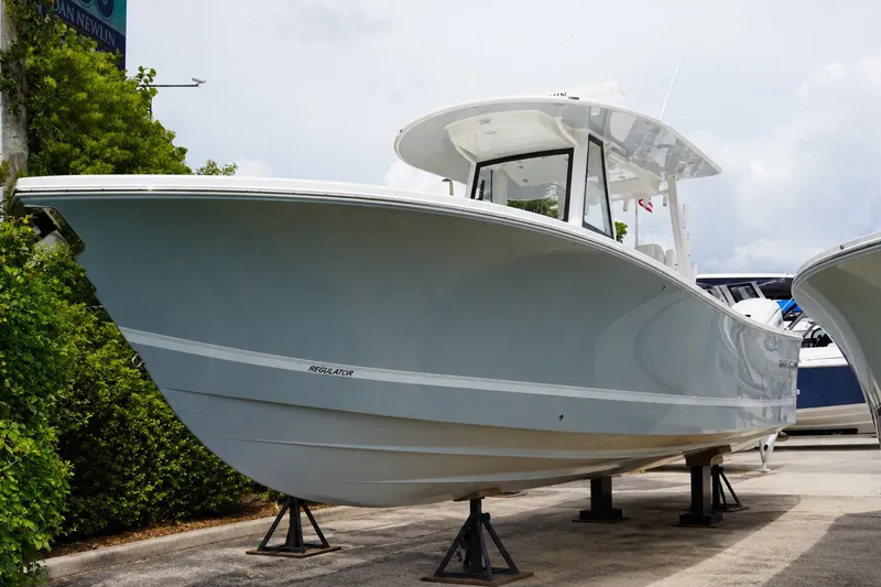 The Image of 2027 Regulator 31 boat displayed outdoors on stands, showcasing sleek design and modern features. - 0