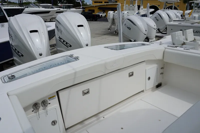 Slide: The Image of 2027 Regulator 31 boat with twin Yamaha V8 engines in a marina setting. - 3