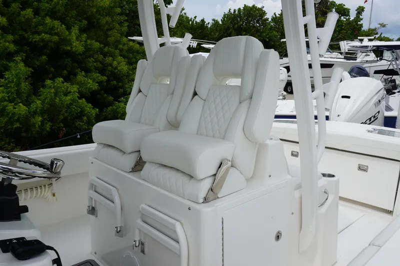 Slide: The Image of Luxurious white seating on 2027 Regulator 31 boat, featuring diamond-stitched upholstery. - 9