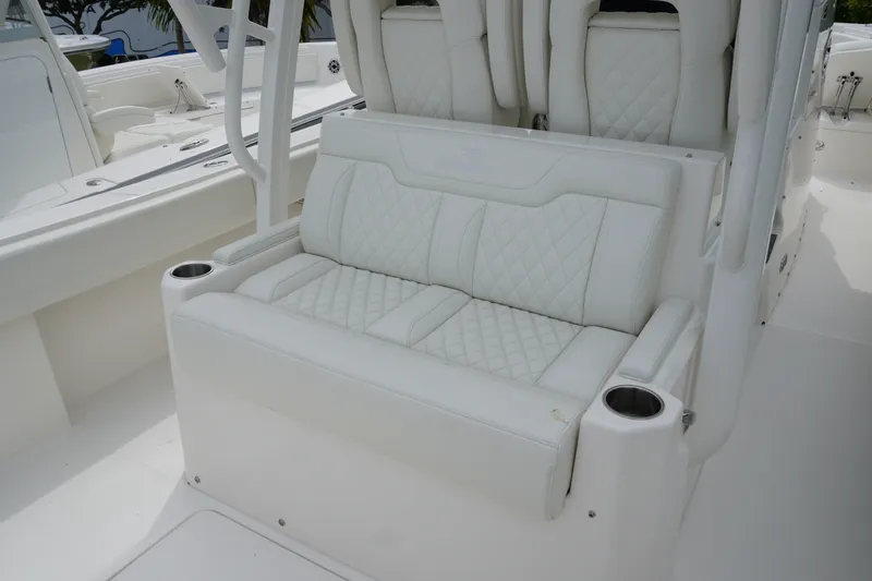 Slide: The Image of Luxurious seating on 2027 Regulator 31 boat with quilted white upholstery and cup holders. - 6
