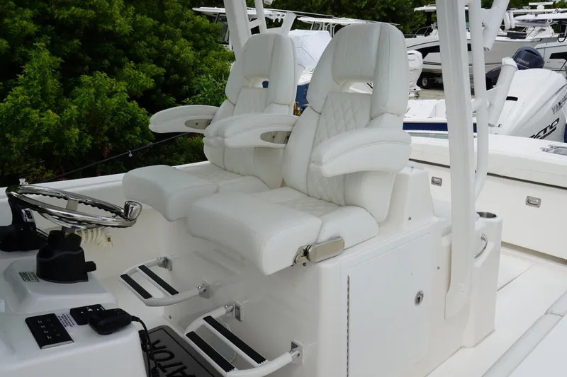 Slide: The Image of Luxurious white seating on 2027 Regulator 31 boat, featuring dual helm chairs and sleek design. - 10